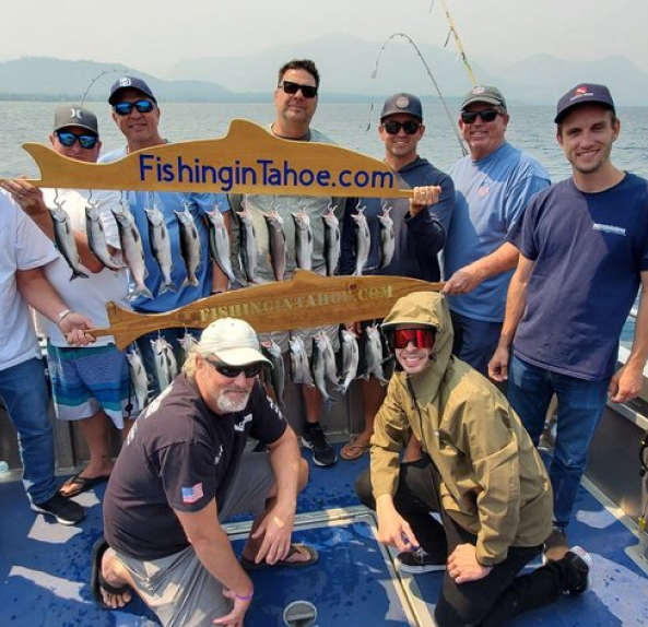 A group of people standing on top of a boat.